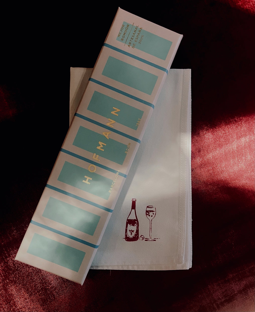 Hofmann label roll on a white towel with a red background