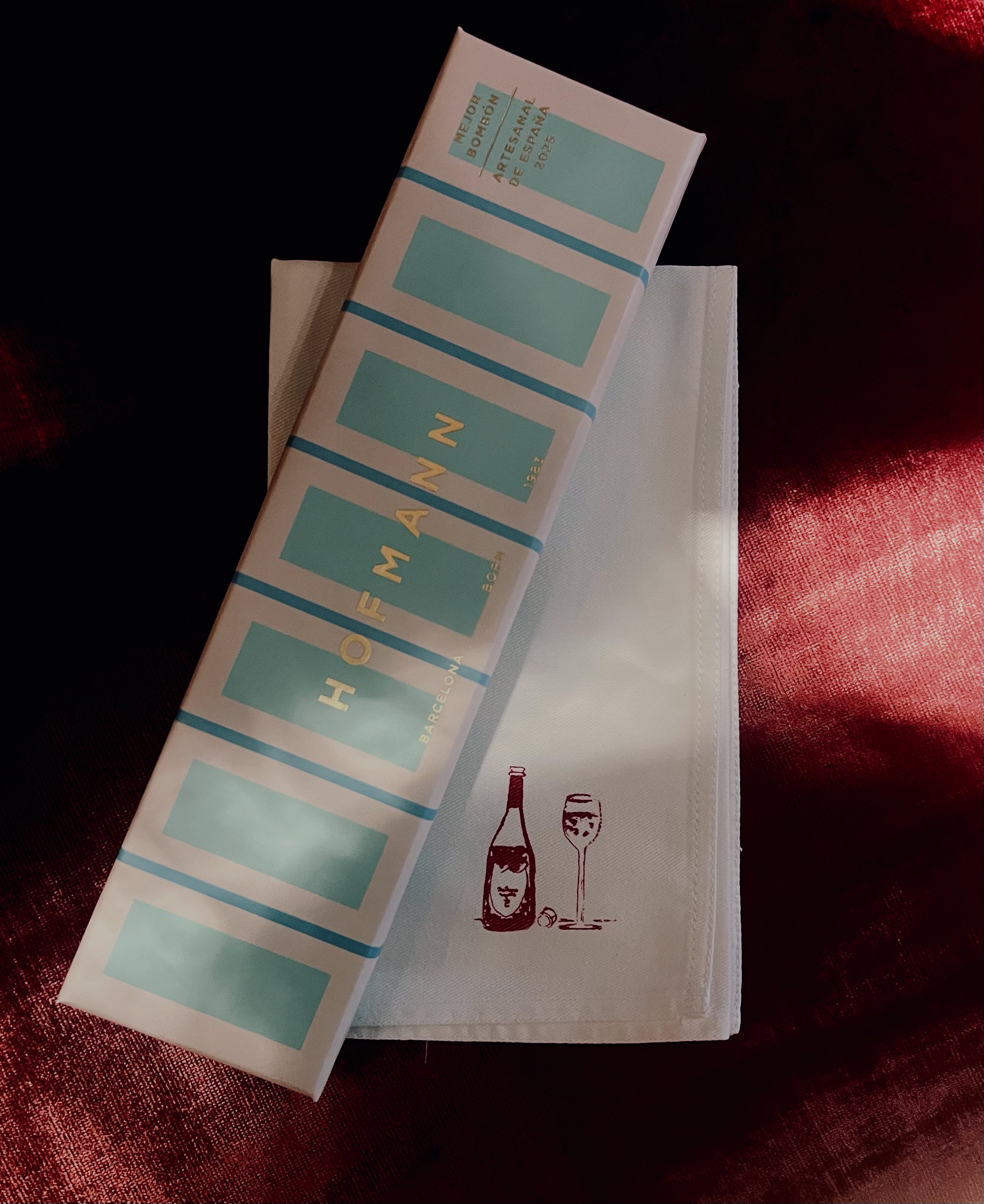 Hofmann label roll on a white towel with a red background